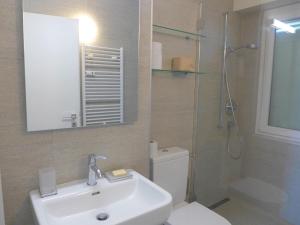 a bathroom with a toilet and a sink and a shower at Apartment Clair-Azur-3 by Interhome in Crans-Montana