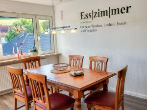 a dining room with a wooden table and chairs at Apartment Am Meintetal by Interhome in Lügde