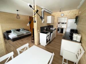 a kitchen and a living room with a couch at Holiday Home The cozy loggers suite by Interhome in Salla