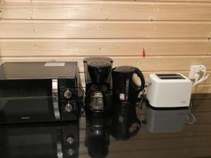 a counter with a microwave and a coffee maker and a toaster at Holiday Home The cozy loggers suite by Interhome in Salla