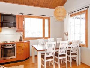 a kitchen with a dining room table and chairs at Holiday Home Tahkon klubitie 6 a by Interhome in Tahkovuori