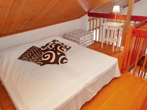 a bedroom with a bed with a pillow on it at Holiday Home Tahkon klubitie 6 a by Interhome in Tahkovuori +8 photos