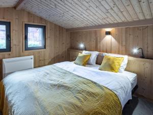 a bedroom with a large bed with yellow pillows at Holiday Home L'Adret by Interhome in Saint-Gervais-les-Bains