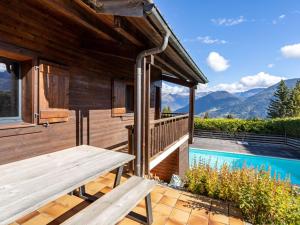 a wooden house with a deck and a pool at Holiday Home L'Adret by Interhome in Saint-Gervais-les-Bains