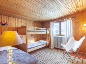 a bedroom with a bunk bed and a chair and a lamp at Apartment Le Grande Motte - Le Lac by Interhome in Tignes