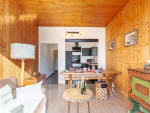a living room with wooden walls and a table at Apartment Le Grande Motte - Le Lac by Interhome in Tignes +18 photos