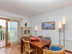 a dining room with a wooden table and chairs at Apartment Sa Riera Beach by Interhome in Begur