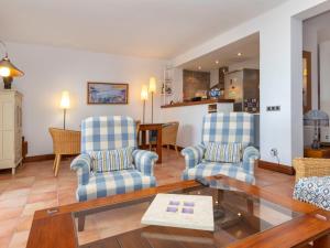 a living room with two chairs and a table at Apartment Sa Riera Beach by Interhome in Begur