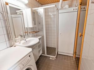 a bathroom with a sink and a washing machine at Holiday Home Ylläs chalets a104 by Interhome in Ylläsjärvi +8 photos