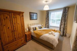 a bedroom with a bed and a window at Church Cottage in Maryport