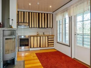 a kitchen with a red rug on the floor at Holiday Home Kelkka 1 by Interhome in Salla