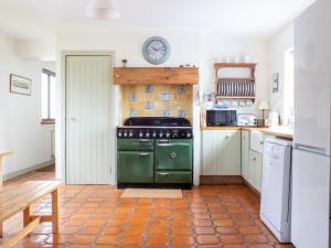 a kitchen with a green oven in a room at Holiday Home Ploughman by Interhome in Eyre
