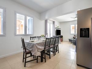 a kitchen and dining room with a table and chairs at Holiday Home Villa Les Treilles by Interhome in Le Racou +25 photos