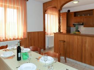 a kitchen with a table with a bottle of wine at Apartment Biletić - LBN374 by Interhome in Barban