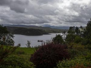 a view of a lake with a boat in the water at Chalet Skye Garden Accommodation by Interhome in Portree