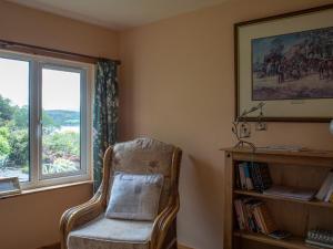 a chair sitting in a room with a window at Chalet Skye Garden Accommodation by Interhome in Portree