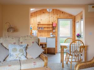 a living room with a couch and a table at Chalet Skye Garden Accommodation by Interhome in Portree