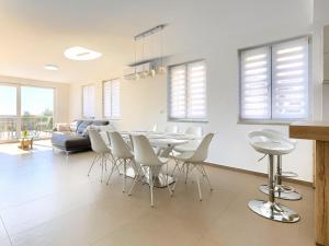a dining room and living room with a table and chairs at Holiday Home Villa Luna Maris by Interhome in Umag