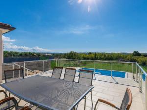 a patio with a table and chairs on a balcony at Holiday Home Villa Luna Maris by Interhome in Umag +28 photos