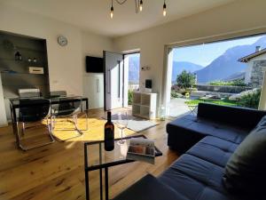 a living room with a blue couch and a glass table at Apartment Ronscione Bellavista by Interhome in San Cassiano