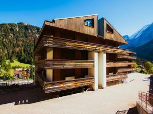 a building with mountains in the background at Apartment Torrita di Canazei by Interhome in Alba di Canazei