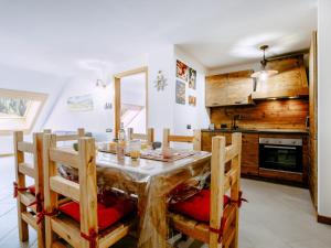 a dining room with a wooden table and chairs at Apartment Torrita di Canazei by Interhome in Alba di Canazei