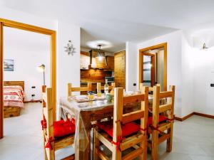 a kitchen and dining room with a table and chairs at Apartment Torrita di Canazei by Interhome in Alba di Canazei