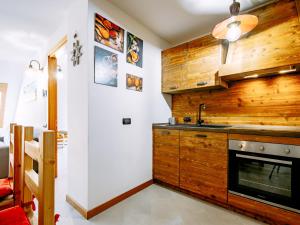 a kitchen with wooden walls and a sink at Apartment Torrita di Canazei by Interhome in Alba di Canazei