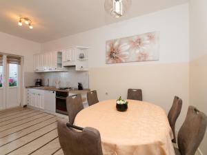 a kitchen and dining room with a table and chairs at Apartment Villa Andro by Interhome in Selca