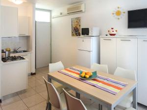 a kitchen with a table with a bowl of fruit on it at Apartment Primula by Interhome in Bibione