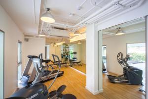 a gym with treadmills and ellipticals in a room at LiT BANGKOK Residence in Bangkok