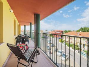a balcony with chairs and a view of a street at Apartment Appartamento Pietrasanta by Interhome in Pietrasanta
