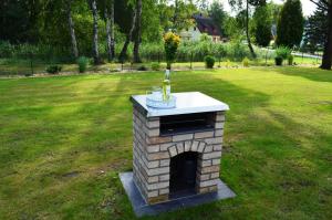 a brick fireplace with a bottle of wine on top at Ferienhaus Wellenbrecher in Ostseebad Karlshagen