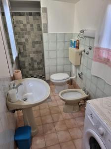 bagno con lavandino e servizi igienici di Casa Toloi a Dorgali