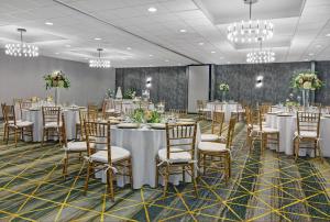 a banquet hall with tables and chairs and chandeliers at Holiday Inn Philadelphia-Cherry Hill by IHG in Cherry Hill +162 photos