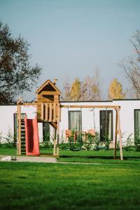a house with a play set and a playground at TERMAL KRE-SPA in Sînnicolau de Munte