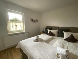 a bedroom with two beds and a window at Panoramahotel Lilienstein in Königstein an der Elbe +19 photos