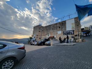 a car parked in front of a building at Home away from home in Safed