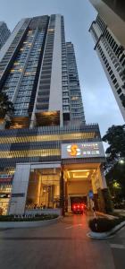 a large building with a parking garage in front of it at TRILLION SUITES by SLG in Kuala Lumpur