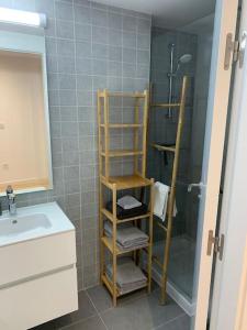 a bathroom with a shower and a towel rack at Prachtig appartement met zeezicht in Estepona Costa del Sol in Estepona