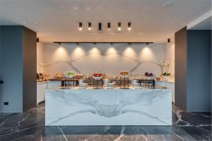 a lobby with a marble counter with stools at EALA My Lakeside Dream - Adults Friendly in Limone sul Garda
