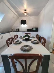 a kitchen with a table with chairs and a tableablish at Très Bel appart charmant 85m2 parking gratuit in Molsheim