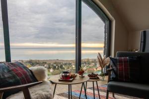 a living room with a large window with a view at Villa Salve in Badacsonytomaj