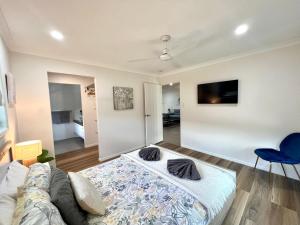 a living room with a bed and a couch at Bundys Best! Modern Luxury in the heart of town in Bundaberg