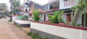 a house with plants on the side of a street at RED LION in Varkala