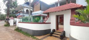 a small house with a window on a street at RED LION in Varkala +14 photos