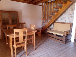 a dining room with a table and chairs and a staircase at Casa da Porta velha in São Gião