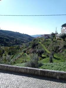 a view of a grassy hill with houses on it at Casa da Porta velha in São Gião