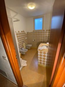 a bathroom with a toilet and a sink at Taverna MaFé in Arzachena