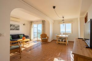 a living room with a couch and a table at Bahia 653 in Nerja